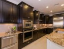 Kitchen with Granite countertops and Dark Cabinets
