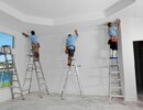 carpenters installing crown moldingBuilding and Construction